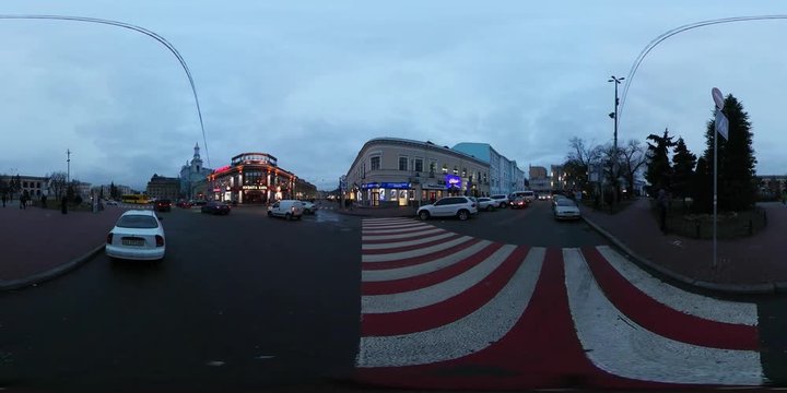 360 vr Video Red and White Crosswalk Cars Driven Nearby Square of Contracts Kiev Downtown Cityscape Illuminated Buildings on a Horizon Cloudy Evening
