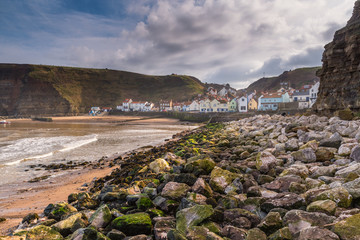 Fototapeta na wymiar Rocks in Staithes Harbour / Staithes is a pretty seaside village and fishing port on the North Yorkshire coastline, and is today an attractive tourist destination