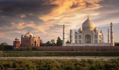 Papier Peint photo Monument artistique Taj Mahal Agra au coucher du soleil vu de Mehtab Bagh sur les rives de la rivière Yamuna. Taj Mahal désigné comme site du patrimoine mondial est un chef-d& 39 œuvre du patrimoine et de l& 39 architecture indienne.
