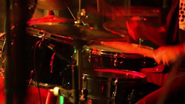 drumming in colored lights. metal concert