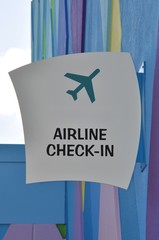 Airline check-in sign posted on the wall of the building