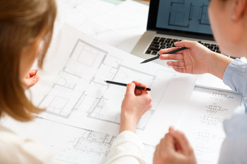 Designers work on a blueprint of new apartments