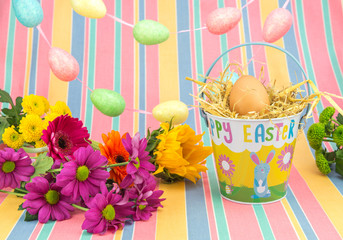 Easter display, flowers, eggs, bucket, bright spring colours.