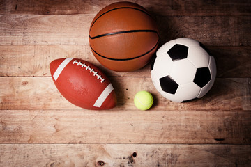 Sports balls on wooden background