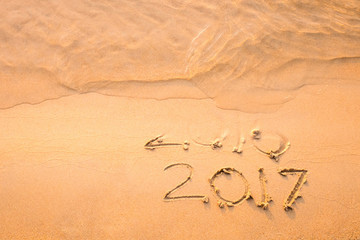 Happy New Year 2017 replace 2016 text on the sea beach, New Year is coming concept.