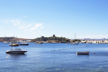 Luxury yachts, sailing and fishing boats in Bodrum bay. Famous landmark castle, was built from 1402 onwards, by the Knights of St John as the Castle of St. Peter or Petronium, is in the background.