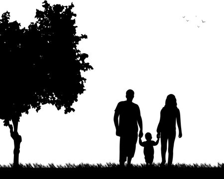Family walking with their child in park, one in the series of similar images silhouette