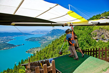 Hanggliding over Lac Annecy, France. Town of Annecy in the far distance. Town of Talloires on...