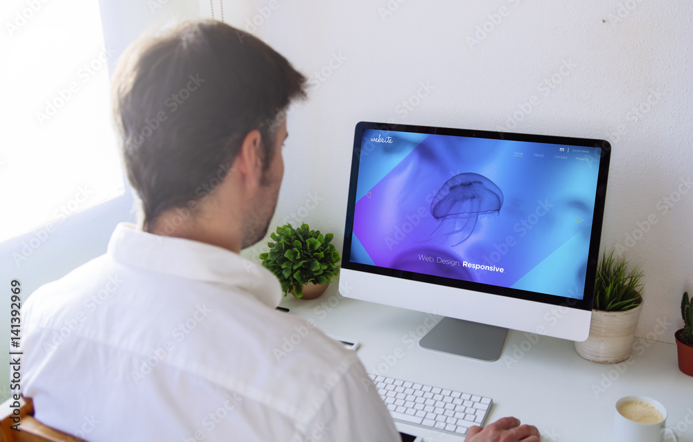 Poster man designing website on computer