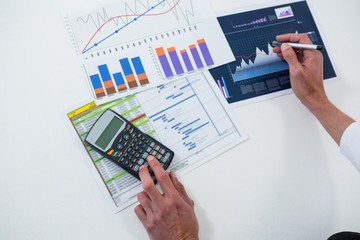 Hands calculating on graph