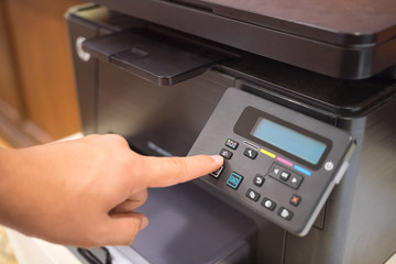 Copier Start, Finger pressing the start button on multifunction printer or copier