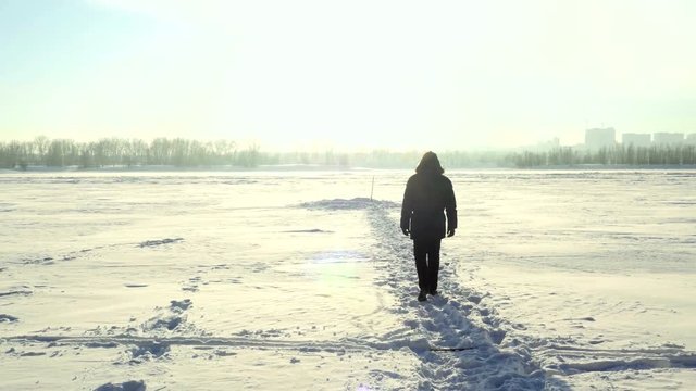 Man steps in the snow in winter. 3840x2160