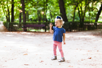 Little girl is looking into the phone