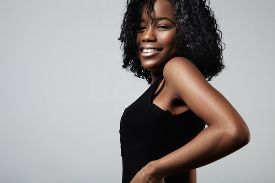 pretty smiling black woman with curly short hair