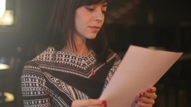 girl in cafe reads the contract