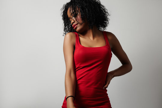 black woman in red dress showing beauty body