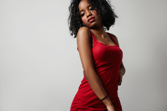 black woman in red dress showing beauty body