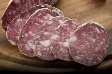 wooden cutting board with salami and bread