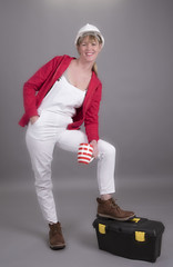 Woman worker wearing a hard hatand holding a mug