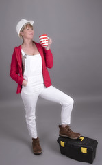 Woman worker wearing a hard hatand holding a mug