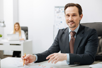 Cheerful smiling businessman working in the office