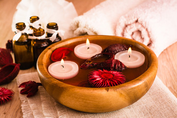 Предметы для спа-процедур. Свечи, эфирные масла, вода, цветы и полотенца.