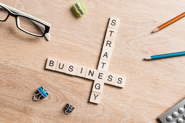 Conceptual business keywords on table with elements of game making crossword