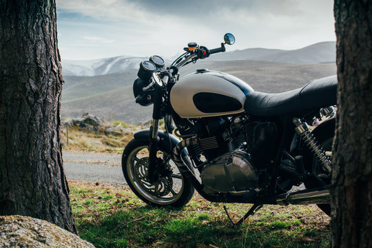 Caf&eacute; racer motorbike in a forest road