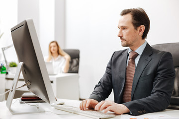 Confident businessman using computer in the office