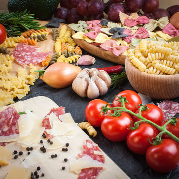 Pasta,  tomatoes, salami and cheese on the table