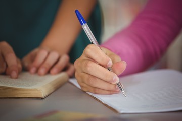 School kids doing homework in library