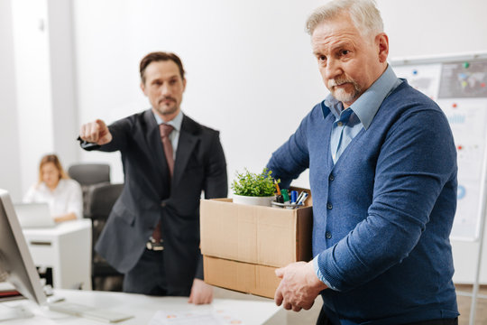 Confident employer firing the employee from the company