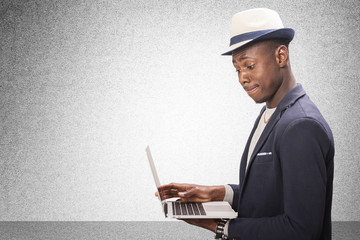 Man standing using a laptop