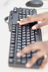 Hands on the computer keyboard.