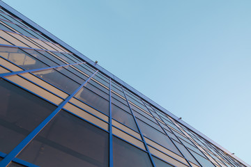 Fototapeta na wymiar The glass facade on the background of blue sky