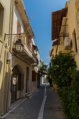 Fototapeta na wymiar Rethymno, Greece - August 4, 2016: Narrow venetian street on old town.