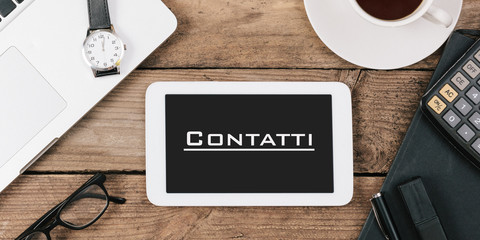Contatti, Italian text for Contacts on screen of tablet computer at office desk