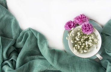 Creative composition with cup and natural flowers.