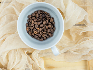 coffee beans on a wood box with cloth