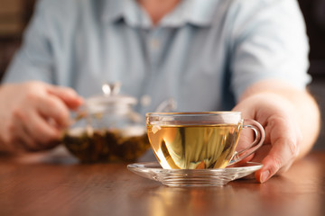 man offer tea cup