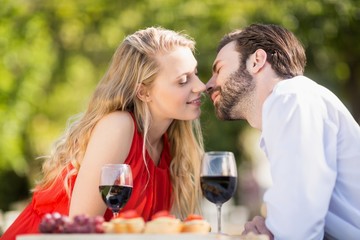 Couple leaning over to kiss