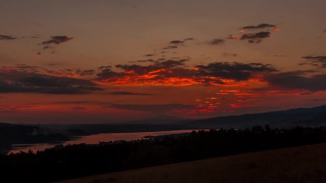 Landscape Time Lapse of Sunset over a Mountain and Lake in the Valley. 4K TimeLapse.