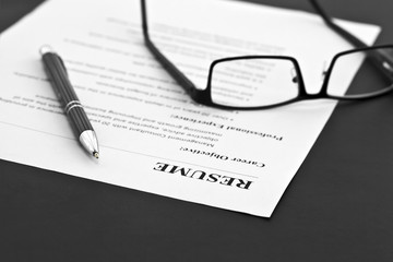 Closeup of Resume with Pen and Glasses on the Table 