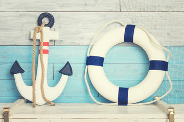 Anchor and lifeline against the background of blue-white boards