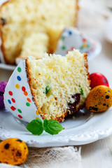 Piece of Easter cake and painted eggs.