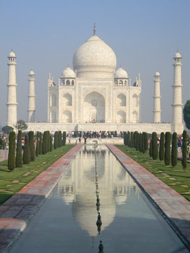 Iconic perspective of the Taj Mahal mausoleum in Agra, India, with the reflection pool and the main building dome framed by the minaret towers.