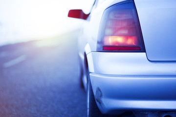 Obraz na płótnie Canvas car speeding on a highway at the sunset