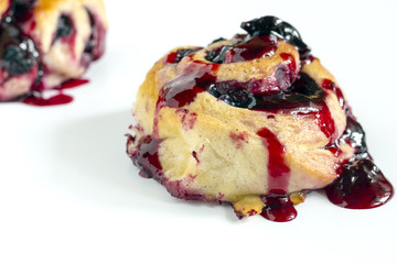 Homemade sweet baked roll with honeyberry preserve on white background