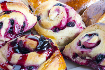 Homemade sweet baked roll with honeyberry preserve on white background