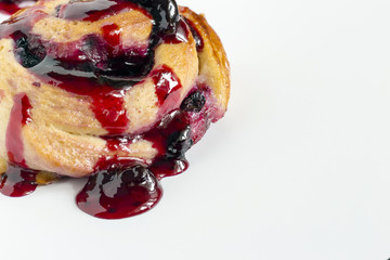 Homemade sweet baked roll with honeyberry preserve on white background
